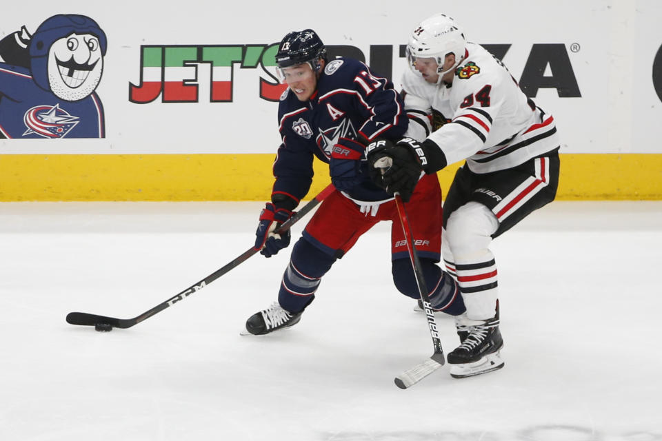 Columbus Blue Jackets' Cam Atkinson, left, controls the puck as Chicago Blackhawks' Carl Soderberg defends during the third period of an NHL hockey game Saturday, April 10, 2021, in Columbus, Ohio. (AP Photo/Jay LaPrete)