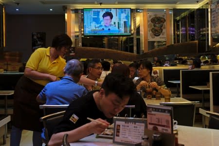 Hong Kong Chief Executive Carrie Lam is seen during live news broadcast on a screen, at a restaurant in Hong Kong