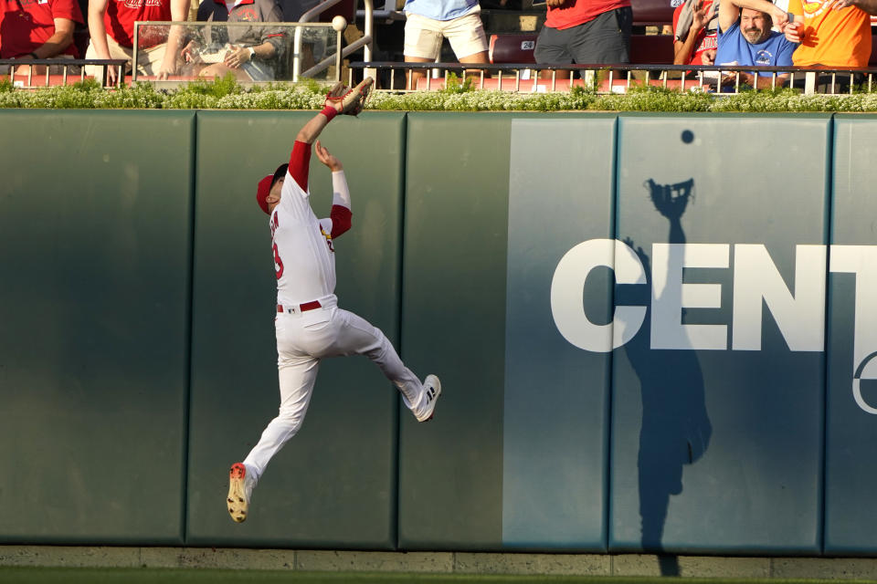 St. Louis Cardinals center fielder Dylan Carlson catches a fly ball by Colorado Rockies' Brendan Rodgers to end the top of the first inning of a baseball game Wednesday, Aug. 17, 2022, in St. Louis. (AP Photo/Jeff Roberson)