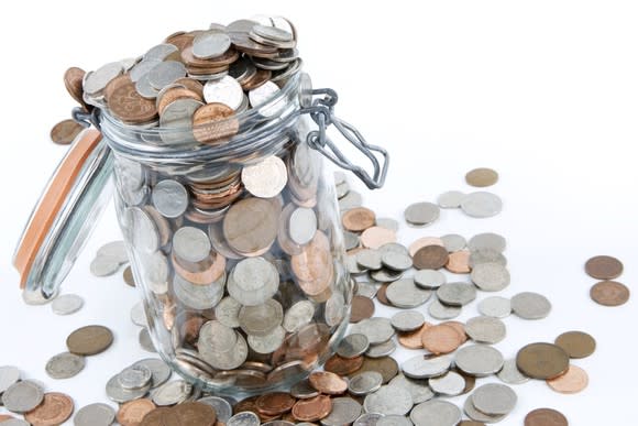 A jar of coins overflowing.