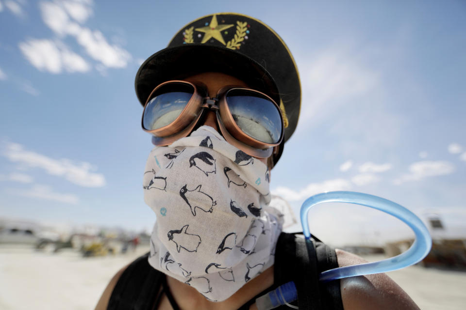 <p>Burning Man participant Marie Sbrocca of San Francisco explores Black Rock City on her bicycle as approximately 70,000 people from all over the world gathered for the 1st full day of the annual Burning Man arts and music festival in the Black Rock Desert of Nevada, Aug. 28, 2017. (Photo: Jim Bourg/Reuters) </p>