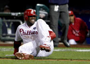 FILE - Philadelphia Phillies' Ryan Howard reacts after falling down injured on his way to first base as he makes the last out during the ninth inning of Game 5 of the National League division baseball series against the St. Louis Cardinals, in Philadelphia, Oct. 7, 2011. For 11 years, Howard’s groundout in the season’s final at-bat served as a flashpoint for a franchise that briefly ruled the NL East, only to fall into a chasm of bad baseball and meaningless Septembers. The Philadelphia Phillies are set to play their first home playoff game since 2011. (AP Photo/Alex Brandon, File)