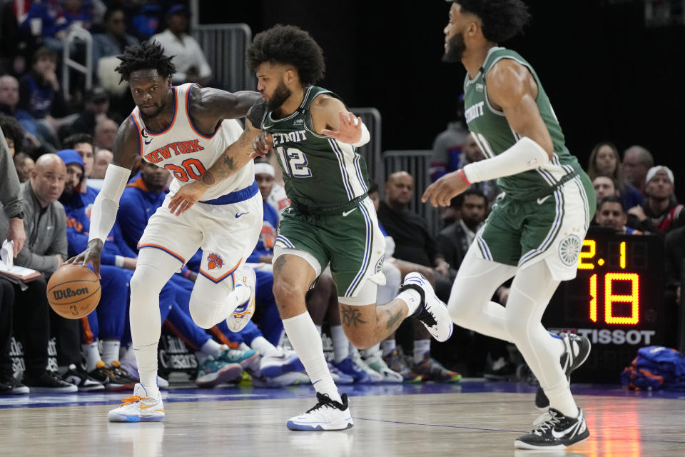 New York Knicks forward Julius Randle (30) brings the ball up court as Detroit Pistons forward Isaiah Livers (12) defends during the second half of an NBA basketball game, Sunday, Jan. 15, 2023, in Detroit. (AP Photo/Carlos Osorio)