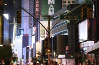 Traffic lights hang without power in Times Square during a power outage, Saturday, July 13, 2019, in New York. Authorities were scrambling to restore electricity to Manhattan following a power outage that knocked out Times Square's towering electronic screens and darkened marquees in the theater district and left businesses without electricity, elevators stuck and subway cars stalled. (AP Photo/Michael Owens)