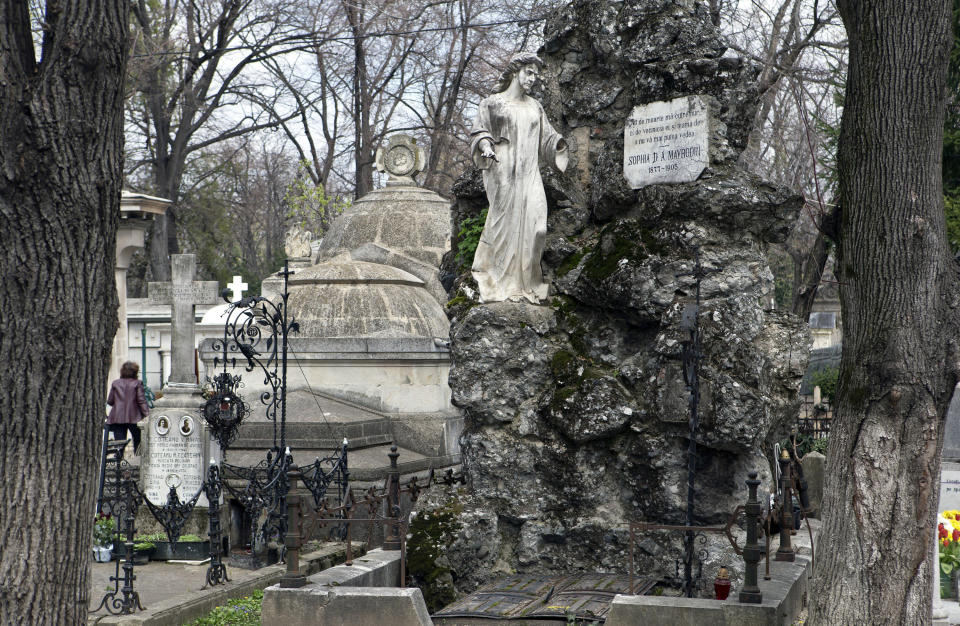 This April 10, 2013 photo shows a statue decorating a grave at the Bellu cemetery in Bucharest, Romania. It was founded by a shepherd, according to local legend, and was later nicknamed the Paris of the East. But Bucharest's idyllic roots and elegant reputation eventually gave way to a series of 20th century calamities: war, invasions, earthquakes and communism.(AP Photo/Vadim Ghirda)