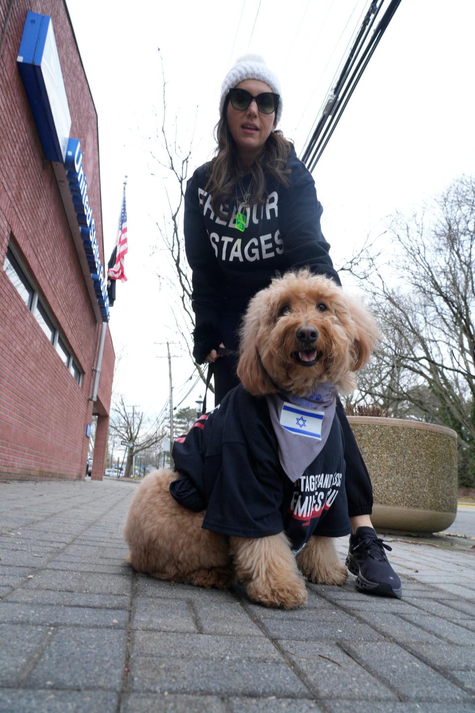 Lisa Schechter, of Englewood, with her dog, Dunkin, during the rally. In Tenafly, NJ on Friday Feb. 9, 2024, the global organization Run For Their Lives holds their weekly walk around Tenafly on Fridays to ask for the release of the hostages in Hamas controlled Gaza.