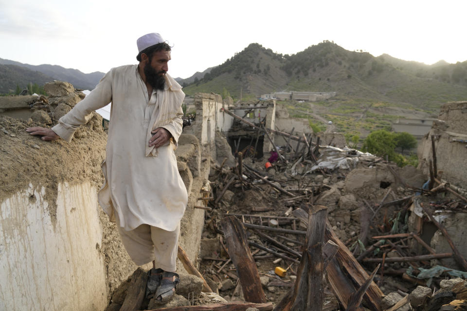 A man stands among destruction after an earthquake in Gayan village, in Paktika province, Afghanistan, Thursday, June 23, 2022. A powerful earthquake struck a rugged, mountainous region of eastern Afghanistan early Wednesday, flattening stone and mud-brick homes in the country's deadliest quake in two decades, the state-run news agency reported. (AP Photo/Ebrahim Nooroozi)