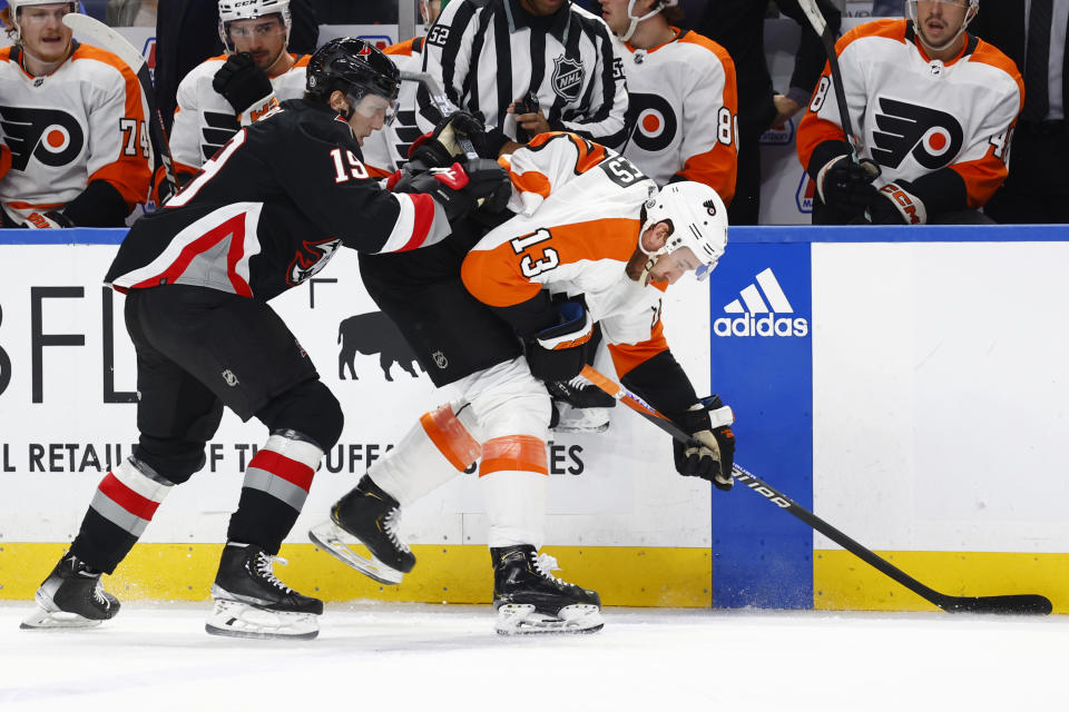 Buffalo Sabres center Peyton Krebs checks Philadelphia Flyers center Kevin Hayes (13) during the second period of an NHL hockey game, Monday, Jan. 9, 2023, in Buffalo, N.Y. (AP Photo/Jeffrey T. Barnes)
