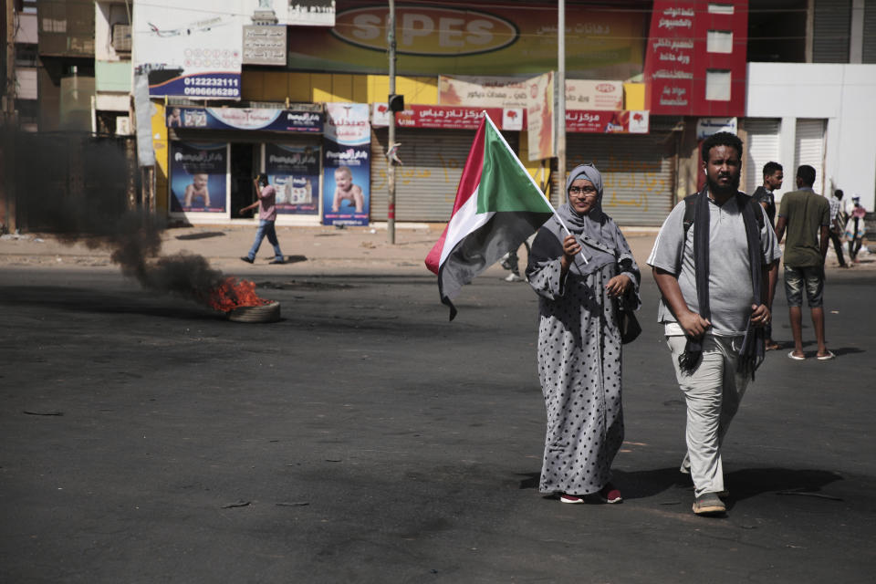 People make their way to join a protest in Khartoum, Sudan, Saturday, Oct. 30, 2021. Pro-democracy groups called for mass protest marches across the country Saturday to press demands for re-instating a deposed transitional government and releasing senior political figures from detention. (AP Photo/Marwan Ali)