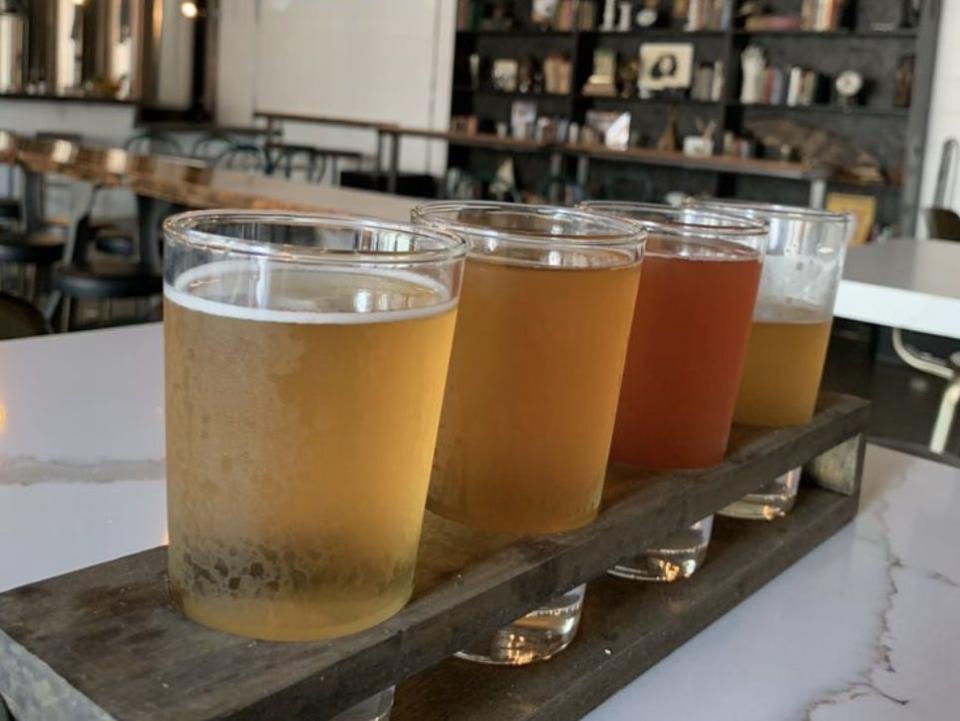 A flight of beers sitting on a table at Tirebiter Brewery