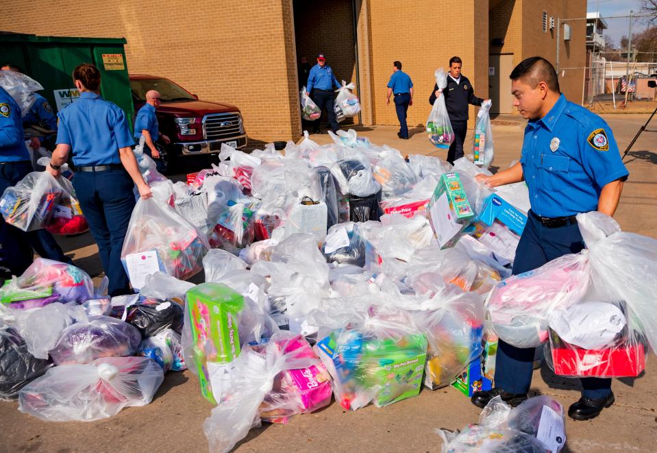 Oklahoma City Fire Department's Chad Forte helps load bags of toys onto a truck for the Oklahoma Institute for Child Advocacy's OK Foster Wishes program in 2019 at the central fire station in Oklahoma City. The fire department accumulated the gifts to fill the wish lists of children in foster care.