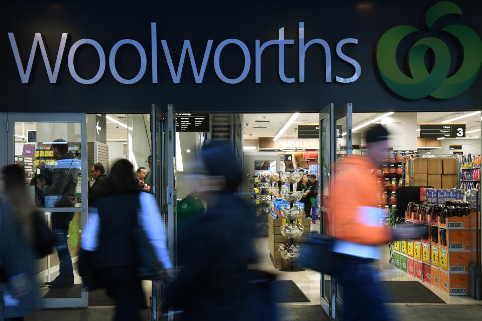 Shoppers walk past a Woolworths store in Sydney.