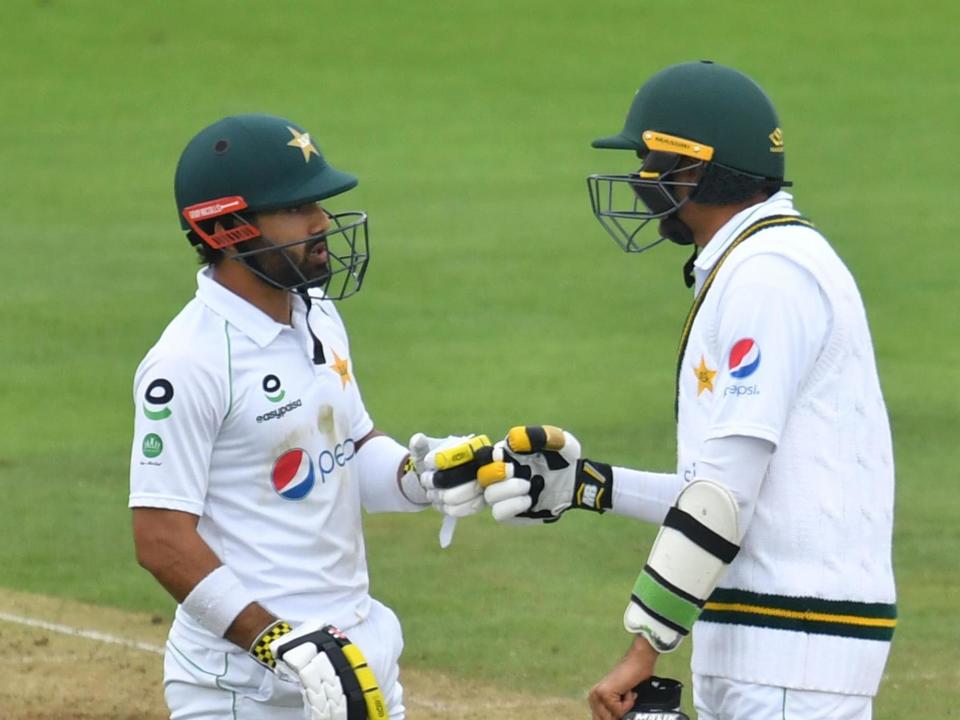 Pakistan's Mohammad Rizwan (left) and Mohammad Abbas talk between overs: POOL/AFP via Getty Images