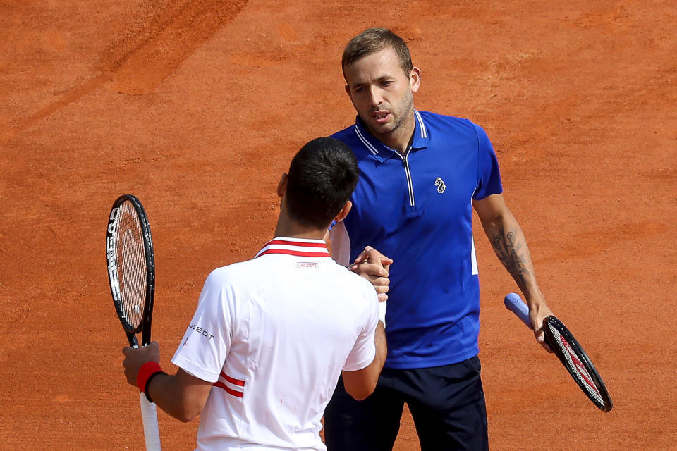 Daniel Evans (picutred right) shakes hands with Novak Djokovic (pictued left) after winning in their third round singles match on day six of the Monte-Carlo ATP Masters Series tournament in Monaco on April 15, 2021.