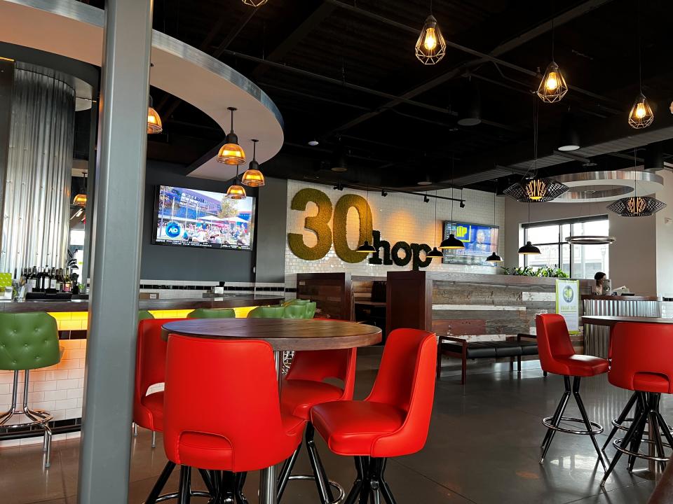 The interior of 30Hop in Ankeny features plenty of televisions and a casual setting.