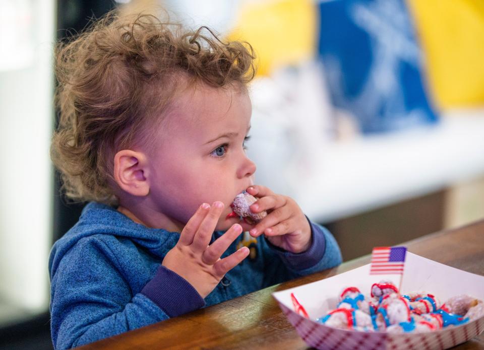 Quinn Reynolds, 20-months, eats a doughnut Monday, June 27, 2022, at Diamond Dough and Co. in Cassopolis.