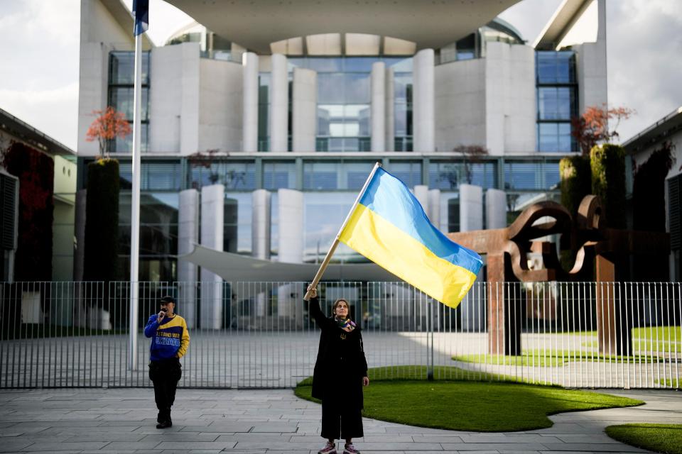 A woman waves a Ukrainian flag as she attends a protest against the war in Ukraine in front of the chancellery in Berlin, Germany, on Oct. 11, 2022.