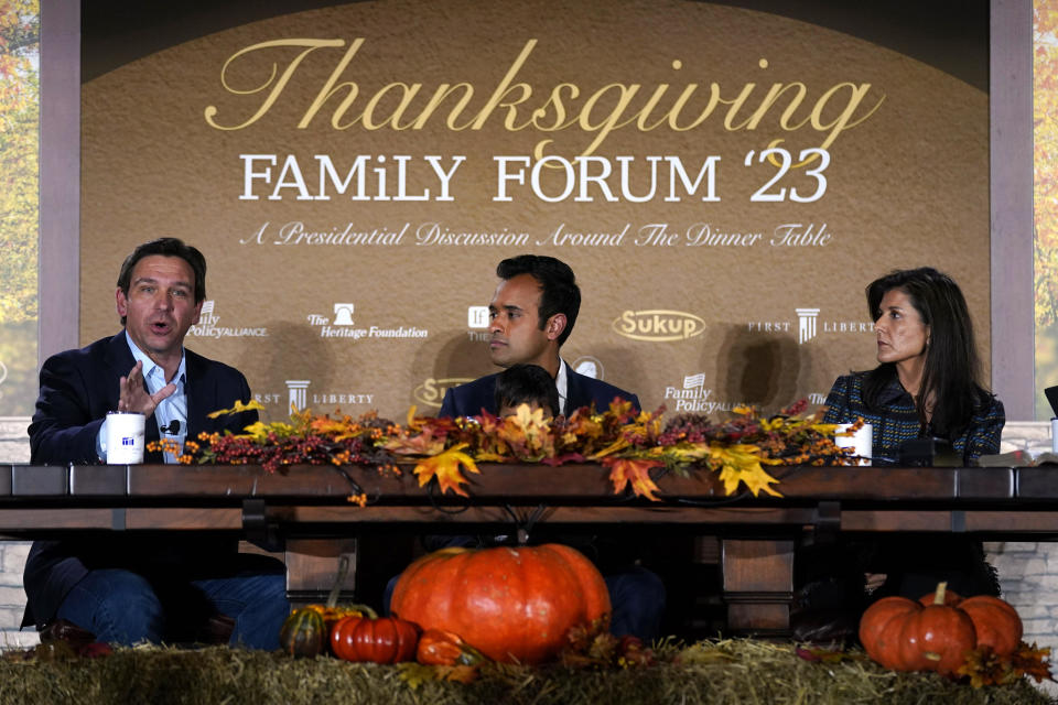 Florida Gov. Ron DeSantis, left, speaks during the Family Leader's Thanksgiving Family Forum as businessman Vivek Ramaswamy, center, and former U.N. Ambassador Nikki Haley, right, look on, Nov. 17, 2023, in Des Moines, Iowa. / Credit: Charlie Neibergall / AP