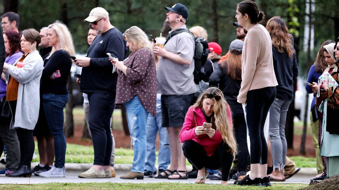 Parents line up at Middle Creek Community Library to check out their children at Middle Creek High School in Apex, N.C., Thursday, April 27, 2023.