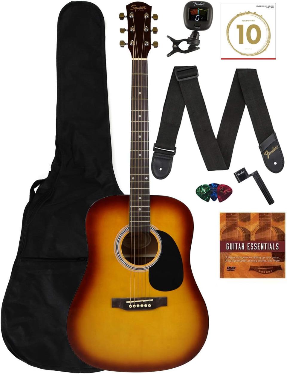 brown acoustic guitar with strap and carrying case