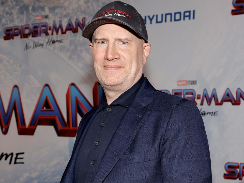 Kevin Feige in a blue suit and baseball cap