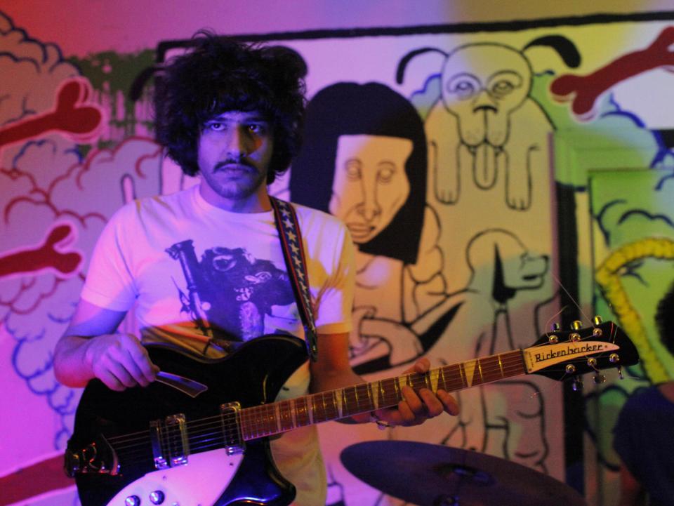 This 2012 photo shows Yellow Dogs band member, guitarist Soroush Farazmand at the Death By Audio performance space in the Brooklyn borough of New York. Police say a musician who shot and killed three other Iranian men inside a New York City apartment before committing suicide was upset because he had been kicked out of an indie rock band. Ali Akbar Mohammadi Rafie gunned down the men just after midnight on Monday, Nov. 11, 2013. Victims Soroush and Arash Farazmand were brothers who played in a band called the Yellow Dogs. The third victim, Ali Eskandarian was also a musician. After the shooting, investigators found a guitar case on a rooftop they believe the shooter may have used to carry the assault rifle used in the attack.(AP Photo/Danny Krug) NO SALES