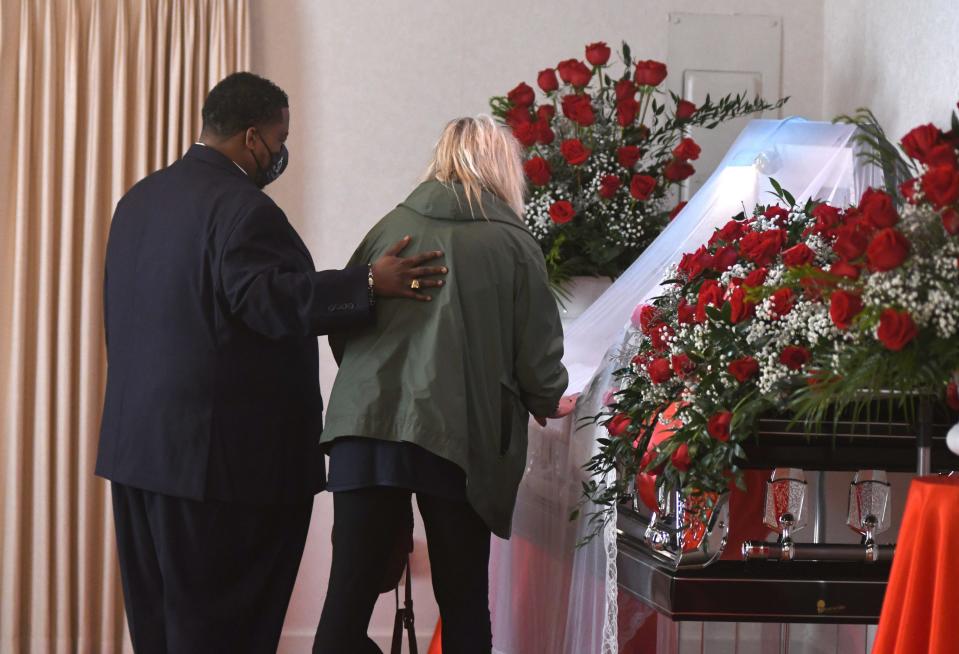 Darius Horton, left, funeral director at Horton's Funeral Home, stands with a mourner paying respects during the public viewing for Andrew Brown Jr. in Hertford, N.C., on May 2, 2021.