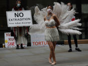 A dancer performs in protest opposite the Central Criminal Court, the Old Bailey, in London, Monday, Sept. 21, 2020, as the Julian Assange extradition hearing to the US continues. (AP Photo/Frank Augstein)