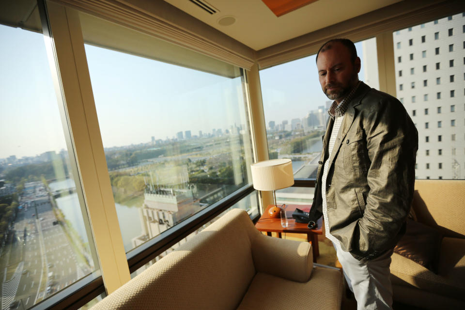 In this Tuesday, April 1, 2014 photo, Noel Biderman, chief executive of Avid Life Media Inc., which operates AshleyMadison.com., poses by a hotel room window overlooking the Imperial Palace grounds during a photo session in Tokyo. Ashley Madison, the world’s biggest online hookup site for married people, works only when monogamy is the rule on the surface but, deep inside, couples want to cheat. That’s why it is scoring big in Japan. (AP Photo/Eugene Hoshiko)