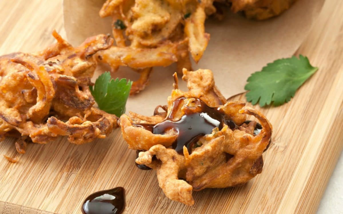 <p>Parade</p><p>Deep fried delicacies like pakoras and kachoris are very common during a Diwali festive meal. Find over 15 quick Indian snacks that are perfect for the Holiday!</p><p><strong>Get the recipe: <a href="/843981/manuzangara/17-indian-street-food-recipes/" data-ylk="slk:Pakora;elm:context_link;itc:0;sec:content-canvas" class="link rapid-noclick-resp">Pakora</a></strong></p>
