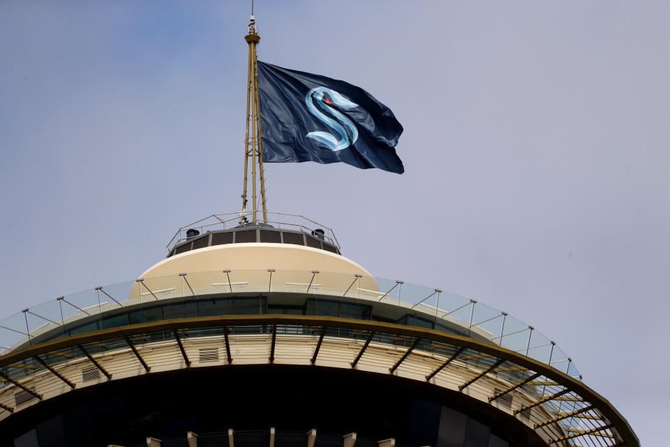 A flag with the new logo for the Seattle Kraken, flies atop the iconic Space Needle Thursday, July 23, 2020, in Seattle.