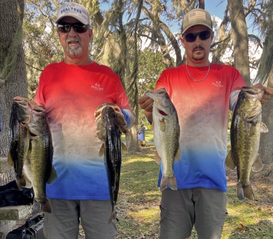 Ken Singletary, left, had big bass with a 6.91 pounder to help him and his partner Steven Singletary to total weight of 20.86 pounds to win first place during Bass N Boats tournament Oct. 15 on the Winter Haven Chain of Lakes. 