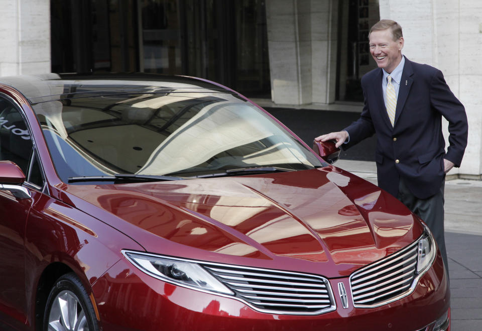 Ford Motor Co. President and CEO Alan Mulally laughs while standing next to a Lincoln MKZ during a press conference, Monday, Dec. 3, 2012 in New York. The MKZ will arrive at dealerships this month. The MKZ is the first of seven new or revamped Lincolns that will go on sale by 2015. (AP Photo/Mark Lennihan)