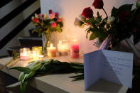 Tributes are placed on a table in an apartment block in Rotterdam, Netherlands, on Friday Dec. 14, 2018, where American student Sarah Papenheim lived. Papenheim, a 21-year-old psychology student at Erasmus University, was fatally stabbed at her home on Wednesday. Police say a 23-year-old man has been arrested on suspicion of involvement in her death. (AP Photo/Mike Corder)