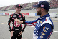 Christopher Bell, left, talks with Ross Chastain after winning the pole during qualifications for a NASCAR Cup Series auto race at Michigan International Speedway in Brooklyn, Mich., Saturday, Aug. 5, 2023. (AP Photo/Paul Sancya)