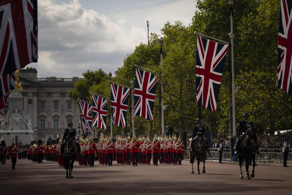 FILE - Guards escort the coffin of Queen Elizabeth II during a procession from Buckingham Palace to Westminster Hall in London, Wednesday, Sept. 14, 2022. On Friday, Sept. 16, The Associated Press reported on stories circulating online incorrectly claiming all funeral services in the U.K. have been canceled on Sept. 19, the day Queen Elizabeth II is set to be buried. (AP Photo/Felipe Dana, File)