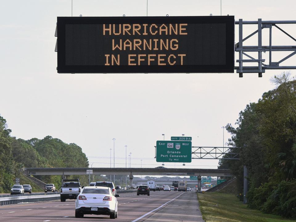 A road sign on I-95 in Cocoa, Florida, advises travelers of a hurricane warning in effect as Tropical Storm Nicole approaches the east coast of Florida on November 8, 2022.