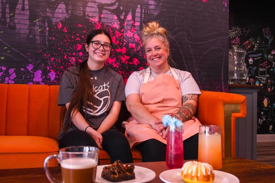 Erica Ashby, right, poses for a photo with her daughter Kaiya, on Aug. 16, 2023, at their store Cupcakes 2 Cakes in Berkeley Place in Bluffton. Ashby plans to offer mocktails paired with desserts for after-movie or after-dinner treats. Pictured from left is a bourbon coffee, rockslide brownie, cotton candy lemonade and a piña colada with a lemon glazed bundt cake in front. Drew Martin/dmartin@islandpacket.com