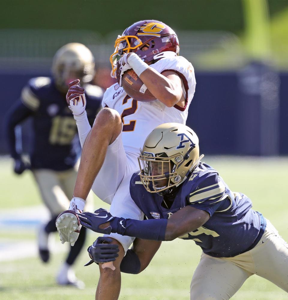 Akron Zips cornerback Darrian Lewis (24) tackles Central Michigan wide receiver Carlos Carriere (2) on Saturday, Oct. 15, 2022, in Akron. Lewis had an interception in UA's spring game Saturday.