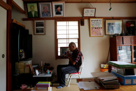 Katsuya Kodama prays in front of an altar for his late wife at his house at Sennari district in Sakura, Chiba Prefecture, Japan, August 29, 2018. REUTERS/Kim Kyung-Hoon