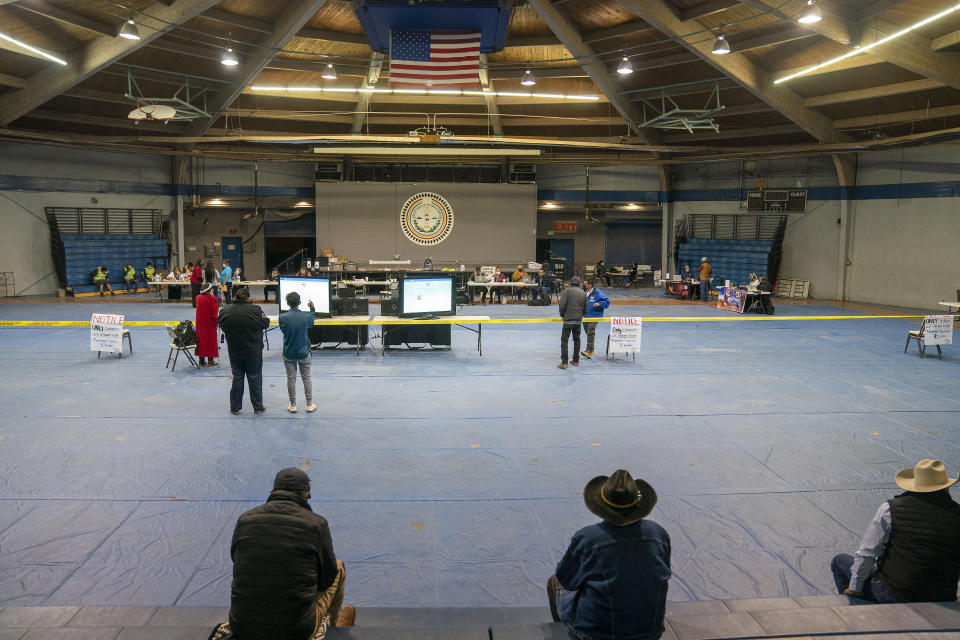 People wait for calls to start coming in to the Navajo Election Administration from the Navajo Nation Chapter Houses, where results are being tabulated, at the Navajo Nation Sports center in Window Rock, Ariz., on Tuesday, Nov. 8, 2022. Navajo voters are deciding Tuesday who they want to be their next tribal president. Buu Nygren is challenging incumbent president Jonathan Nez. (AP Photo/William C. Weaver IV)