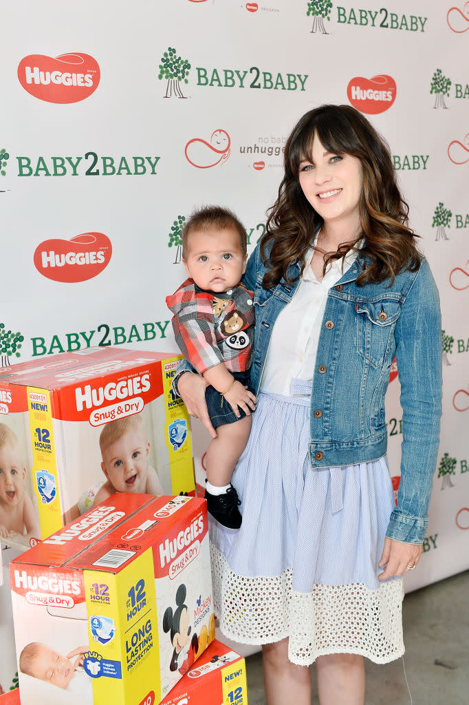 Zooey Deschanel holds a baby (not hers!) at Baby2Baby and Huggies No Baby Unhugged donation event in L.A. on Sept. 25.