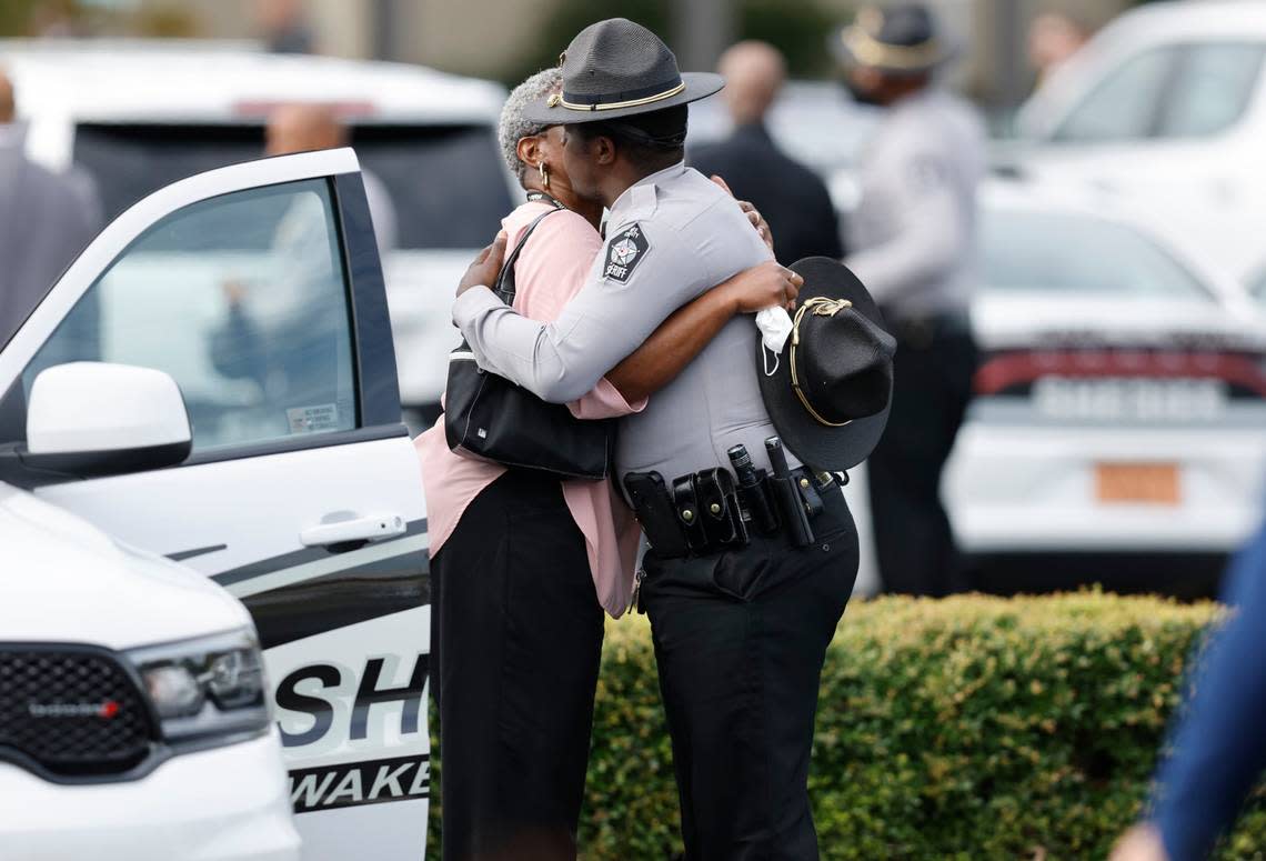 Attendees hug before the funeral for slain Wake County Sheriffs Deputy Ned Byrd at Providence Baptist Church in Raleigh, N.C., Friday, August 19, 2022.