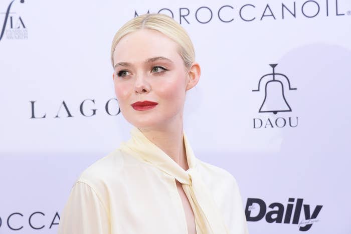 A close-up of Elle looking to the side as she poses for photographers on the red carpet