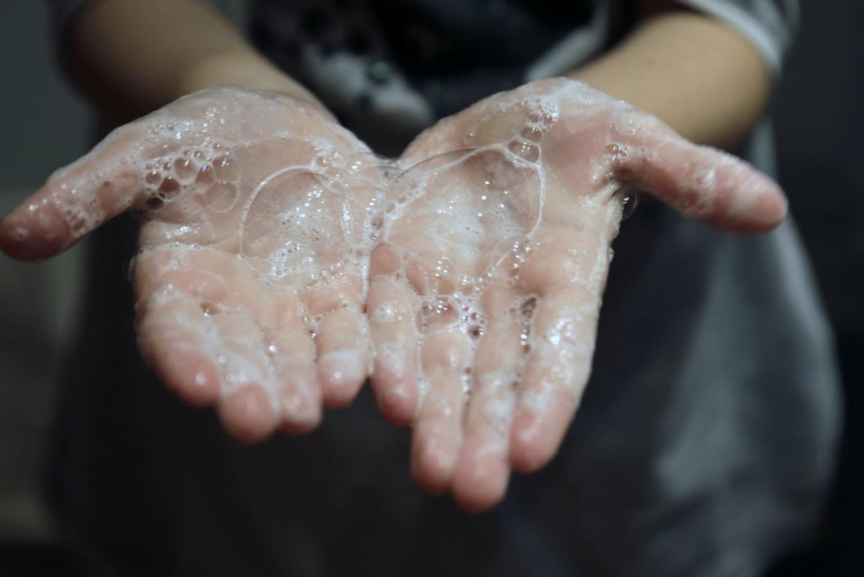 <span class="caption">One thing everyone agrees on: Hand-washing helps prevent the spread of the coronavirus.</span> <span class="attribution"><a class="link " href="https://www.gettyimages.com/detail/photo/close-up-of-hands-with-soap-royalty-free-image/1212576671?adppopup=true" rel="nofollow noopener" target="_blank" data-ylk="slk:Getty Images / Isabel Pavia;elm:context_link;itc:0;sec:content-canvas">Getty Images / Isabel Pavia</a></span>