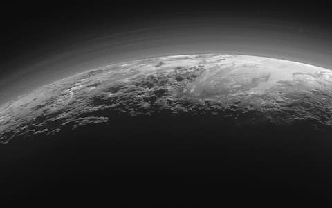 Researchers have discovered Pluto is covered with surprising dunes made of methane ice, which have formed relatively recently despite the frigid dwarf planet's very thin atmosphere - Credit: AFP