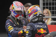 Sprint race winner Red Bull driver Max Verstappen, left, of the Netherlands gestures to third placed teammate Sergio Perez of Mexico at the Chinese Formula One Grand Prix at the Shanghai International Circuit, Shanghai, China, Saturday, April 20, 2024. (AP Photo/Andy Wong)