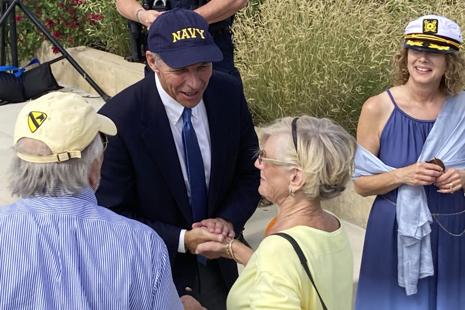 Iowa Democratic U.S. Senate candidate Michael Franken greets supporters with his wife Jordan, right, after a rally in West Des Moines, Iowa, Saturday, Oct. 1, 2022. Franken is facing an uphill final month in his challenge of seven-term Republican Sen. Chuck Grassley. (AP Photo/Thomas Beaumont)