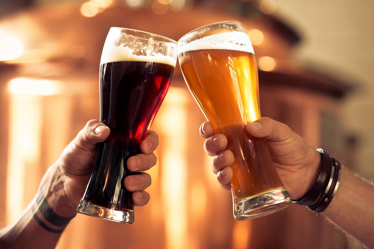 Two friends toast with beer glasses