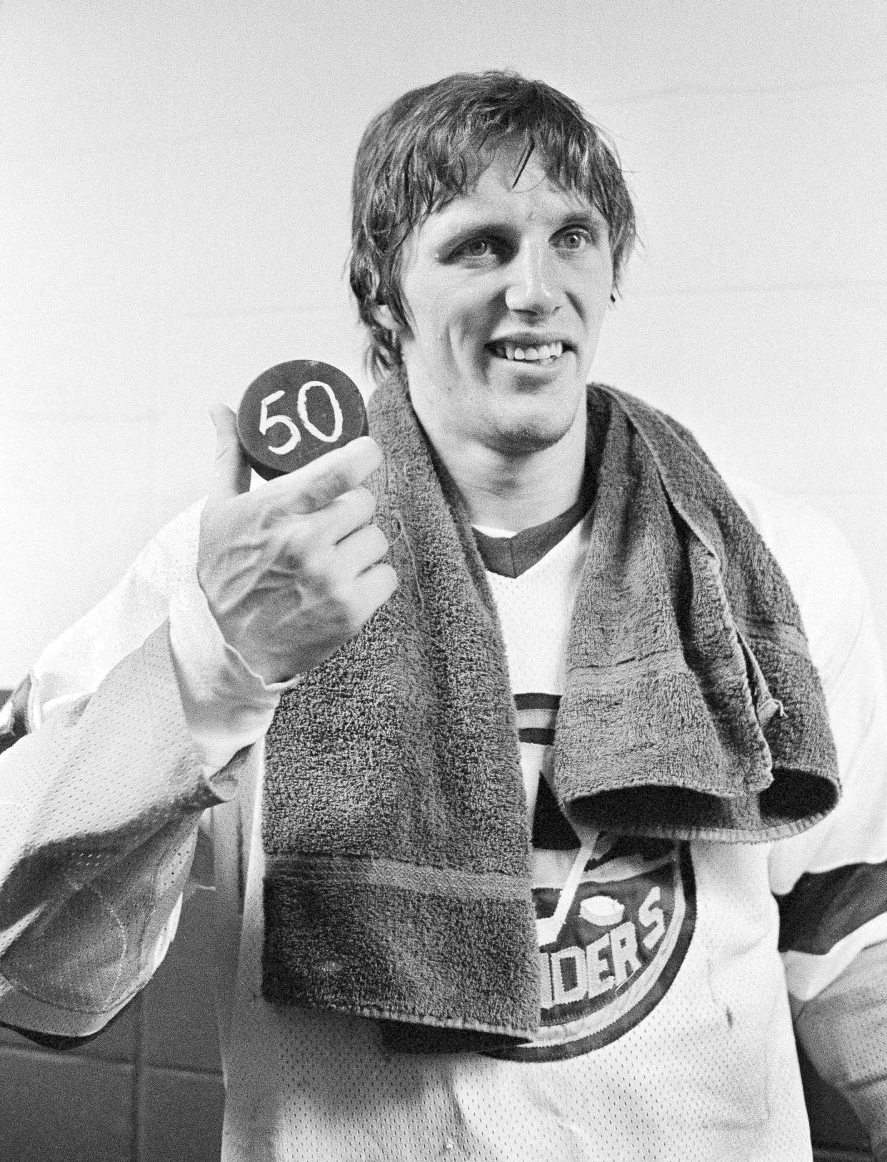 FILE - New York Islanders Mike Bossy holds a puck signifying his scoring 50 goals in his first 50 games, in Uniondale, N.Y., Jan. 24, 1981. Bossy, one of hockey’s most prolific goal-scorers and a star for the New York Islanders during their 1980s dynasty, died Thursday, April 14, 2022, after a battle with lung cancer. He was 65. (AP Photo/Bennett, File)